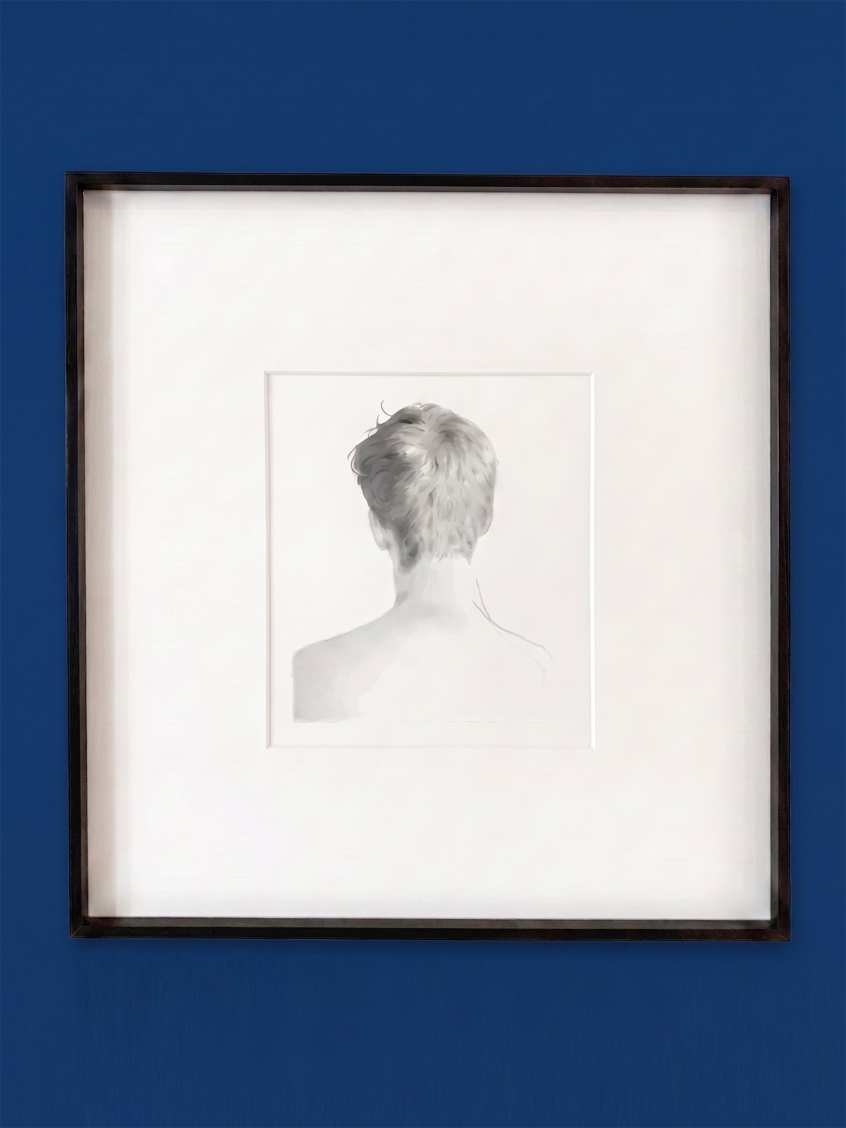 A monochromatic rear-view portrait displayed on a blue wall.
