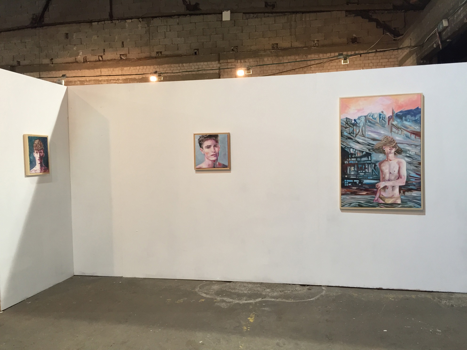 Installation view of three paintings arranged across adjoining white walls.