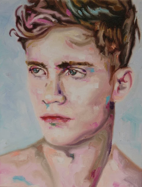 Portrait of a bare-chested young man shown from the shoulders up against a pale background.