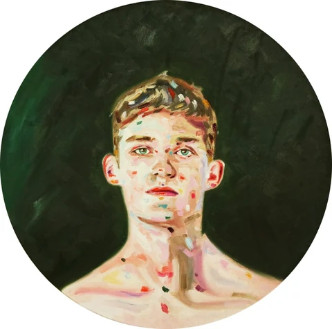 Circular portrait of a bare-chested young man facing forward against a dark green background.