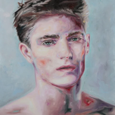 Close portrait of a bare-chested young man against a mottled green background.