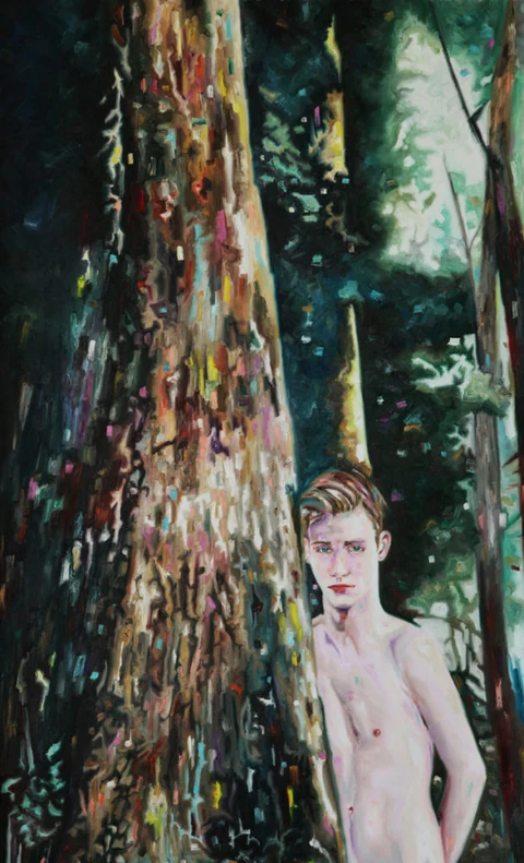 Partly hidden figure beside a large tree trunk in a dense forest.