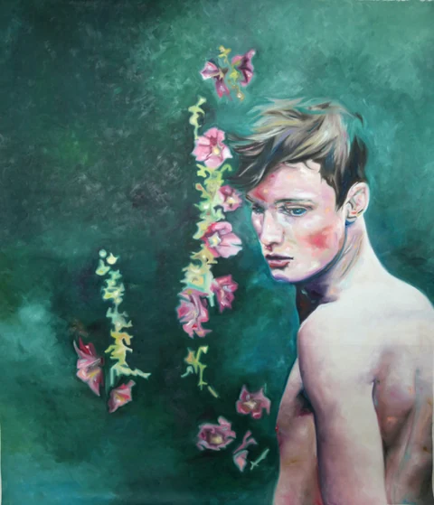 Bare-chested young man turning beside a vertical spray of pink flowers.