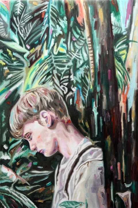 Young man in profile among dense dark foliage and tree trunks.