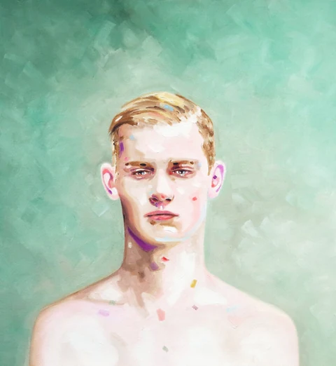 Bare-chested young man facing forward against a pale green background.