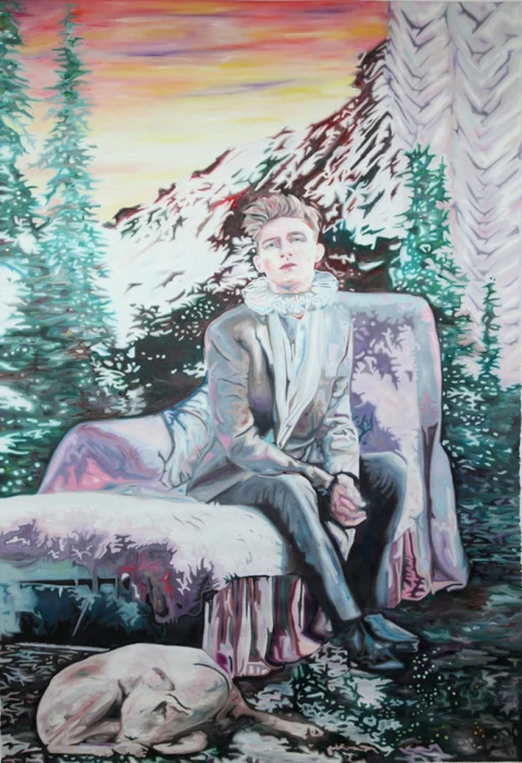 Seated figure outdoors before mountains at sunset, with a reclining animal nearby.