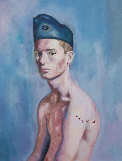 Bare-chested young man in a dark cap shown against a pale blue background.