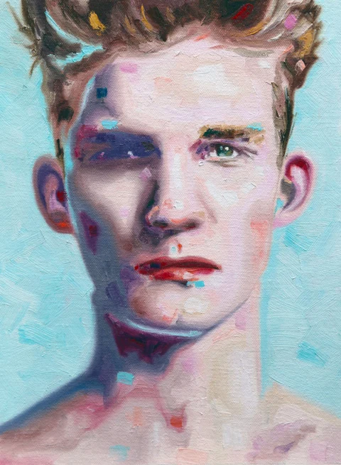 Close portrait of a bare-chested young man against a pale blue background.