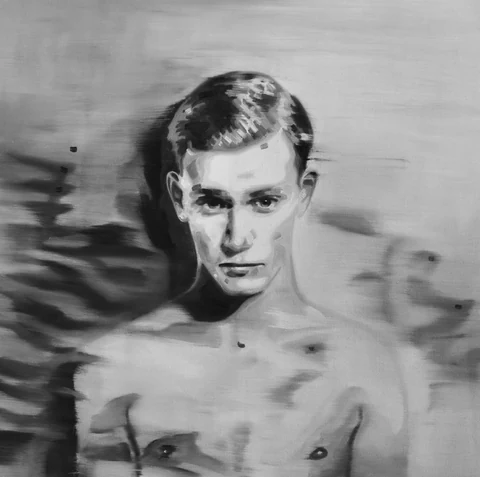 Black-and-white portrait of a bare-chested young man standing in water.