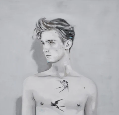 Black-and-white portrait of a bare-chested young man looking to the side.