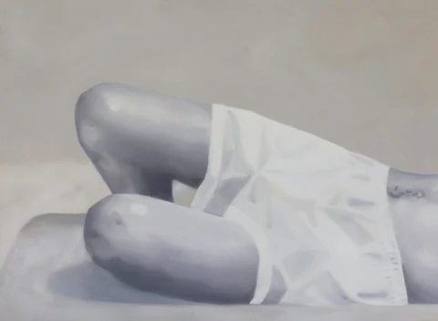 Pale reclining figure with bent legs, shown against a light background.