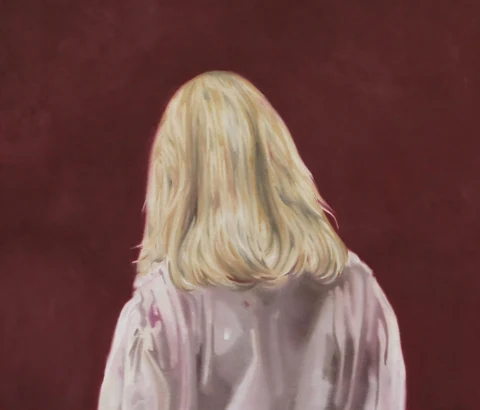 Blond figure seen from behind against a dark red background.