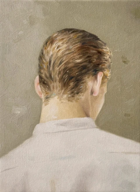 Figure seen from behind wearing a light collared shirt against a neutral background.
