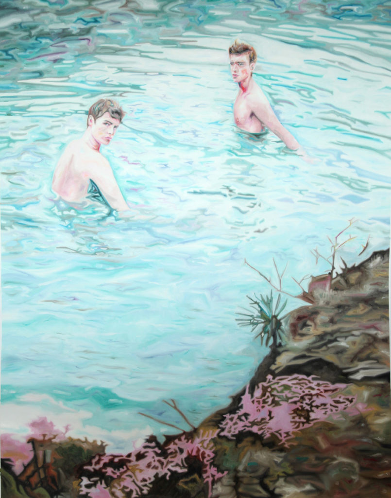 Two figures standing in turquoise water beside a rocky, flowered shoreline.