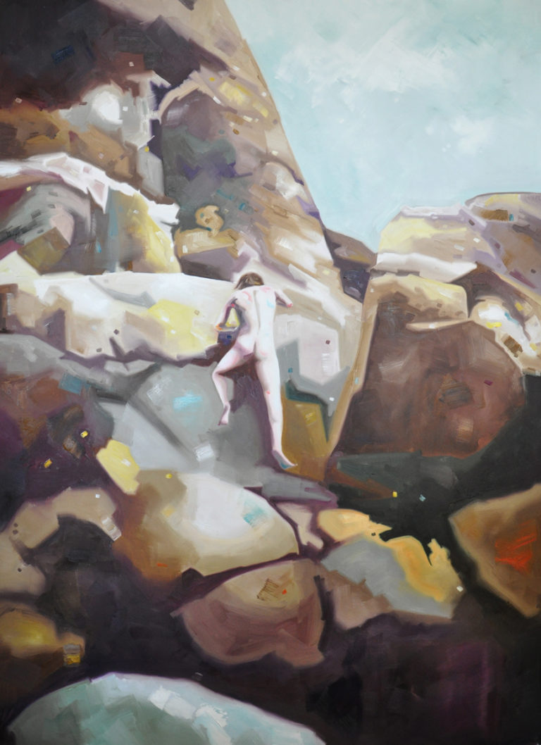Rocky landscape with pale boulders and a narrow stream.