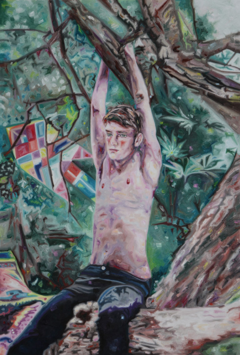 Bare-chested young man with raised arms beneath tree branches in a forest.