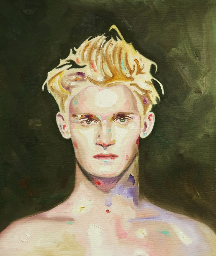 Bare-chested blond young man facing forward against a dark green background.
