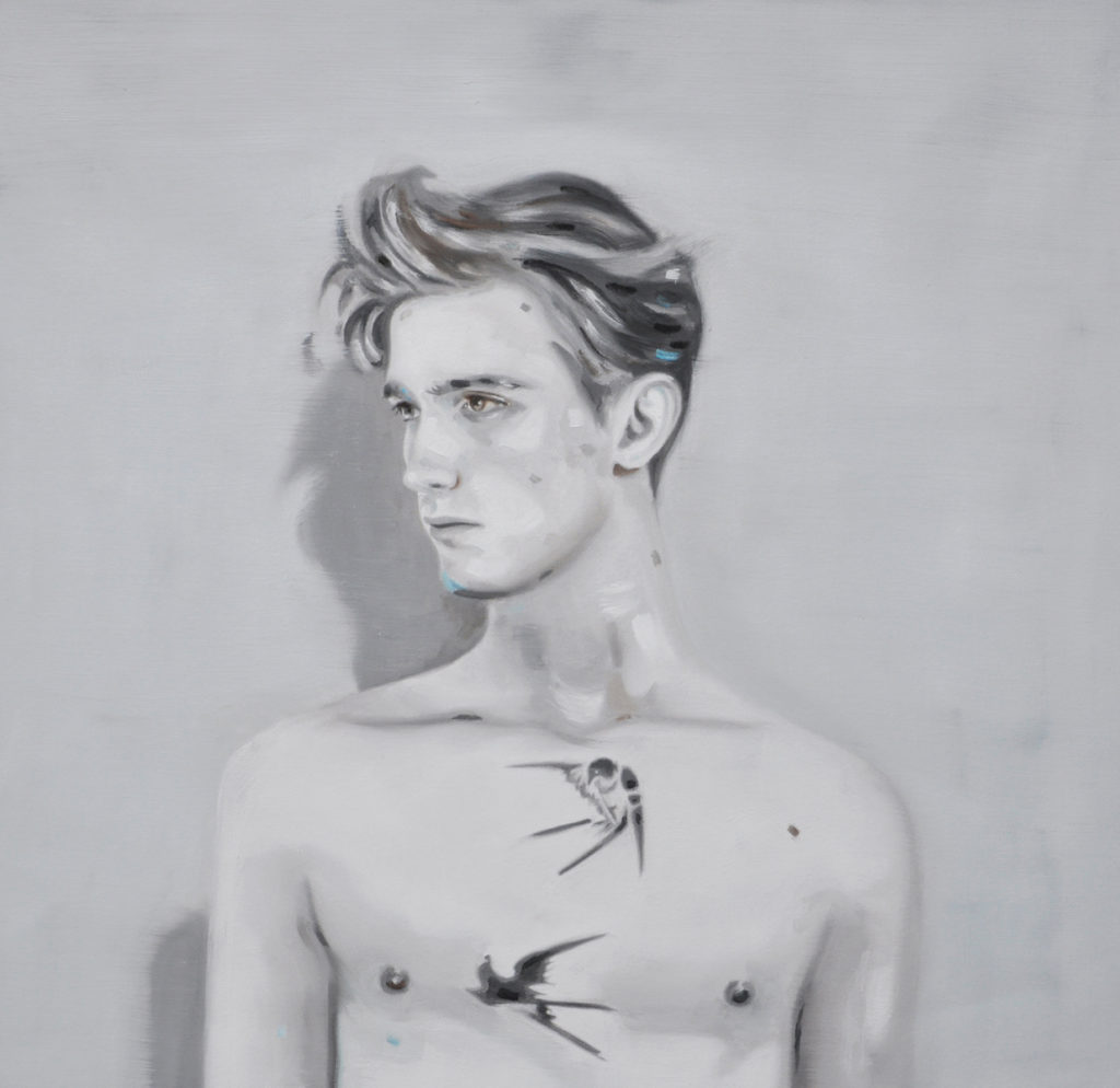 Black-and-white portrait of a bare-chested young man looking to the side.