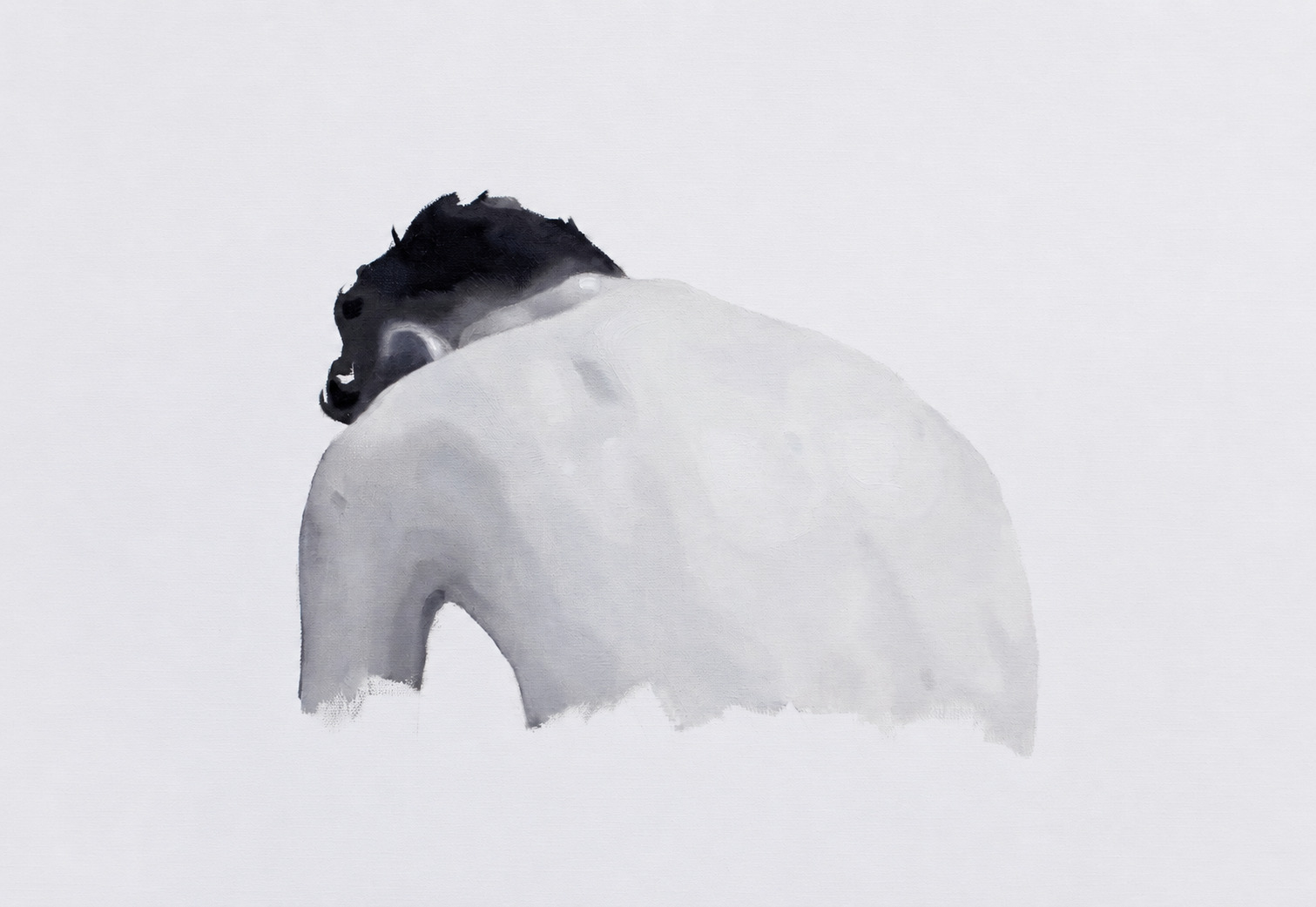 Black-and-white view of a seated figure bent forward, shown from behind.