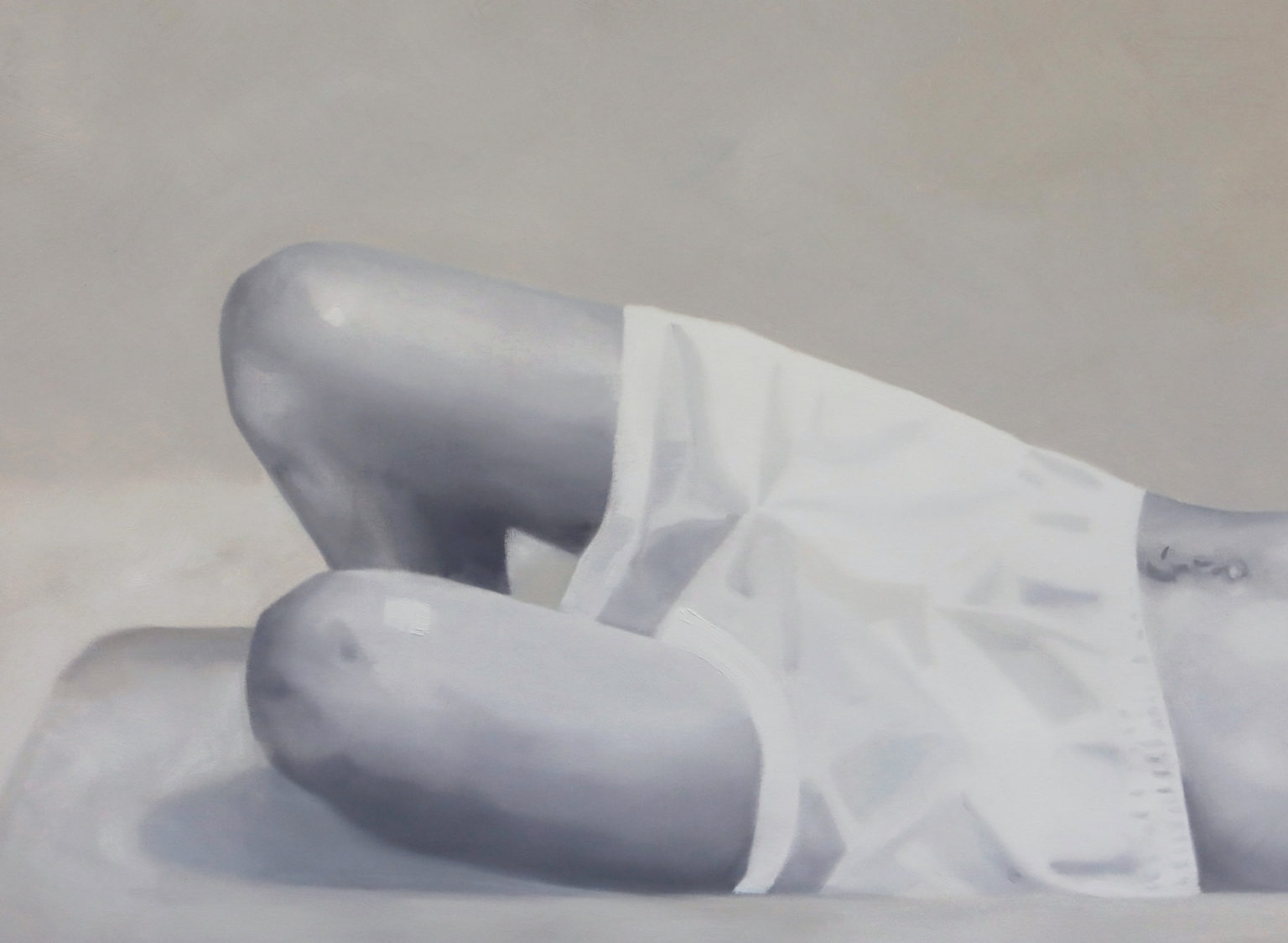 Pale reclining figure with bent legs, shown against a light background.