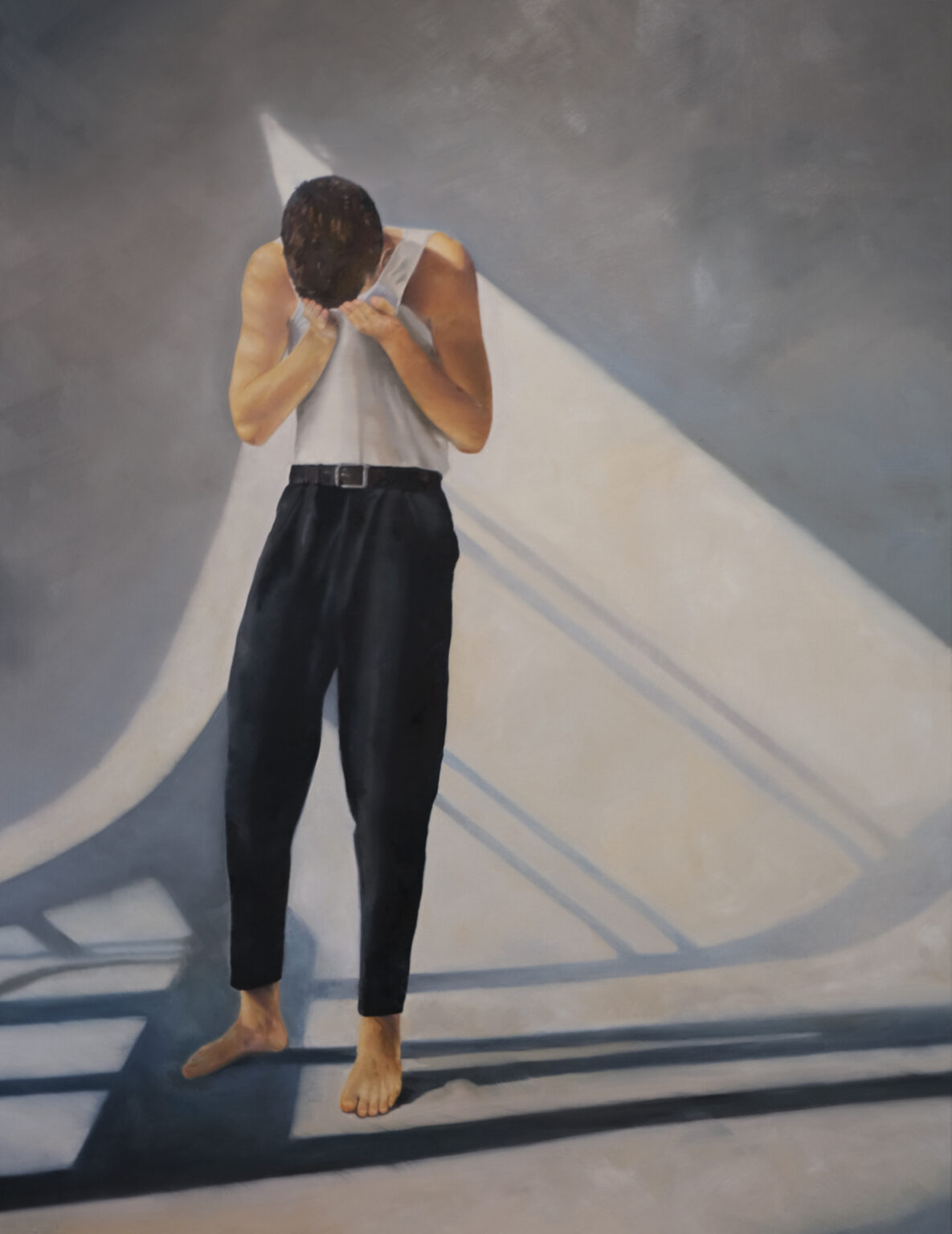 Standing figure in dark clothing shielding the face in a geometric interior.